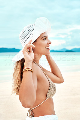 Buy stock photo Shot of a beautiful young woman spending time at the beach on a sunny day