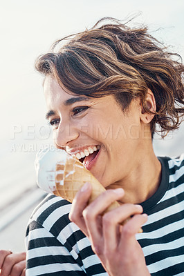 Buy stock photo Cropped shot of a young woman enjoying ice cream outdoors