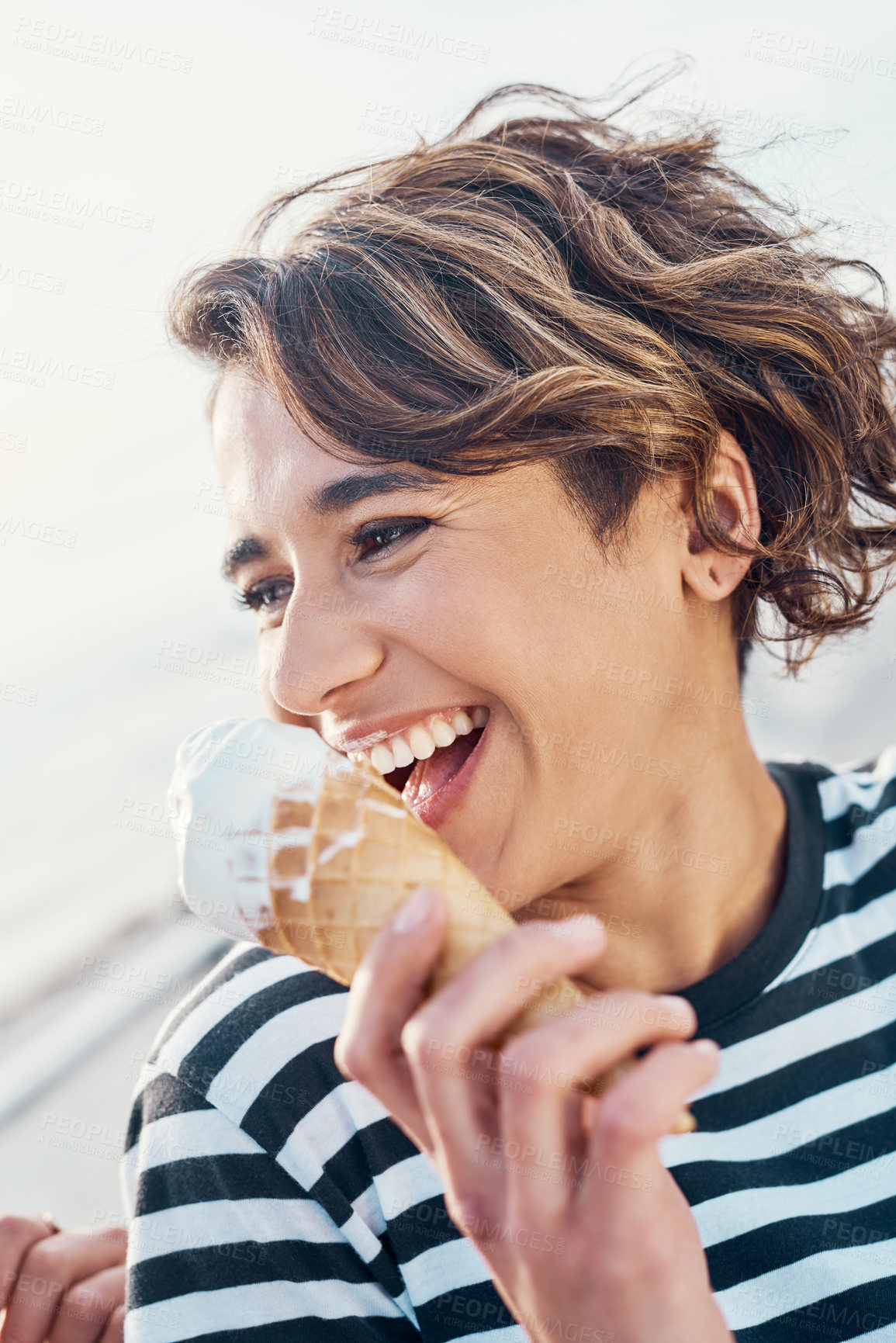 Buy stock photo Cropped shot of a young woman enjoying ice cream outdoors