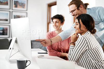 Buy stock photo Cropped shot of a diverse group of businesspeople working on a computer together during a meeting in the office