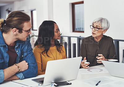Buy stock photo Cropped shot of a group of confident businesspeople having a meeting together inside of the office during the day