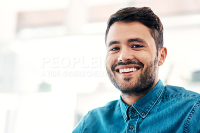 Buy stock photo Cropped portrait of a handsome young businessman smiling while standing in an office office