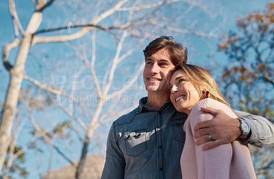 Buy stock photo Shot of a happy young couple spending a romantic day together in the park