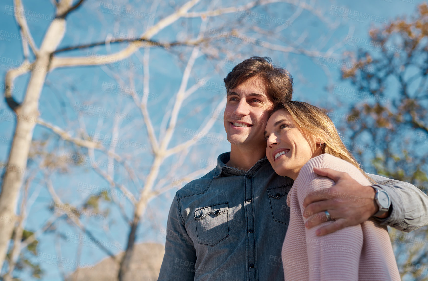 Buy stock photo Shot of a happy young couple spending a romantic day together in the park