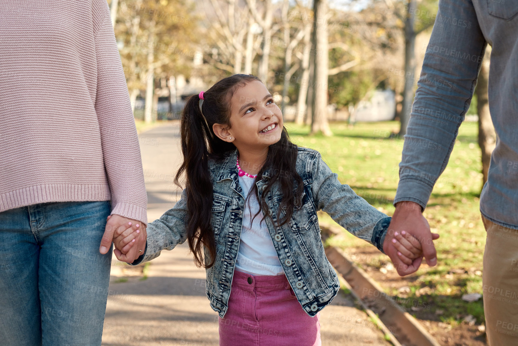 Buy stock photo Girl, walking and happy in holding hands in park on school, holiday or vacation on weekend for growth. Family, bonding and childhood development in nature with smile for memory, together and support