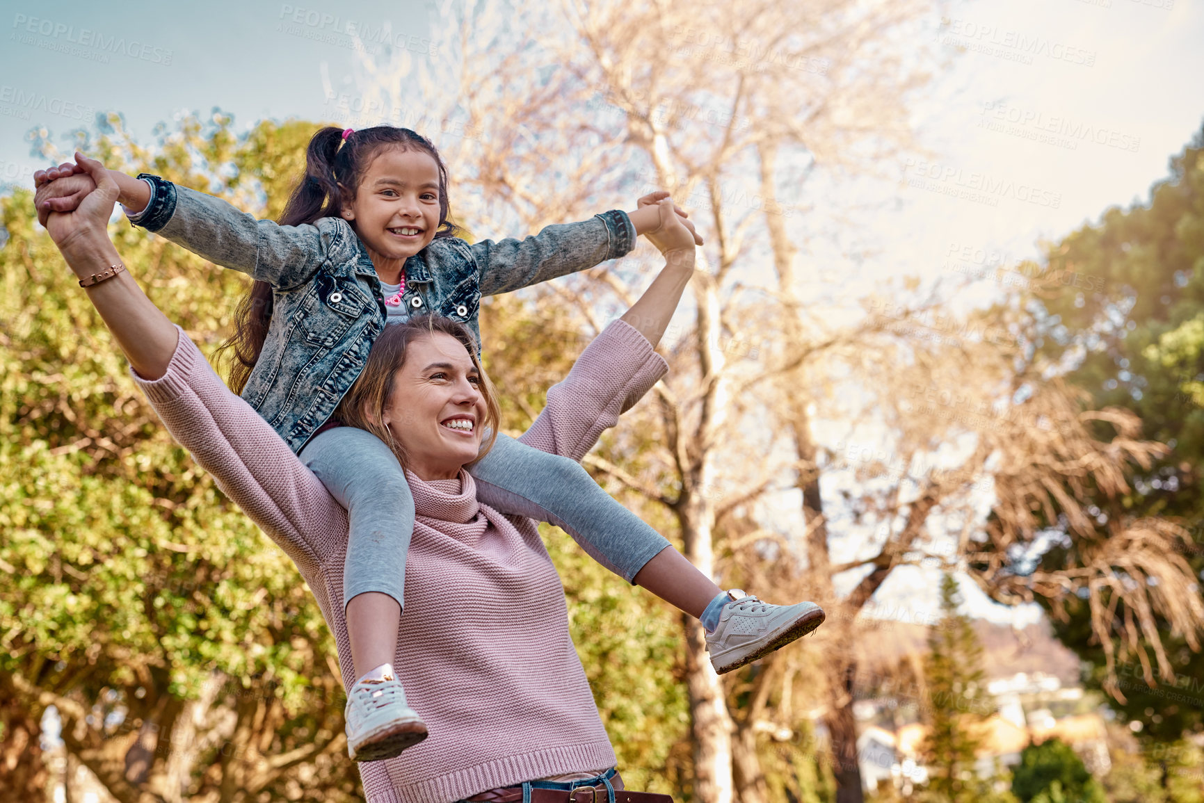 Buy stock photo Shot of an adorable little girl having fun with her mother at the park