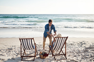 Buy stock photo Rearview shot of a middle aged couple sitting in their beach chairs on the the beach
