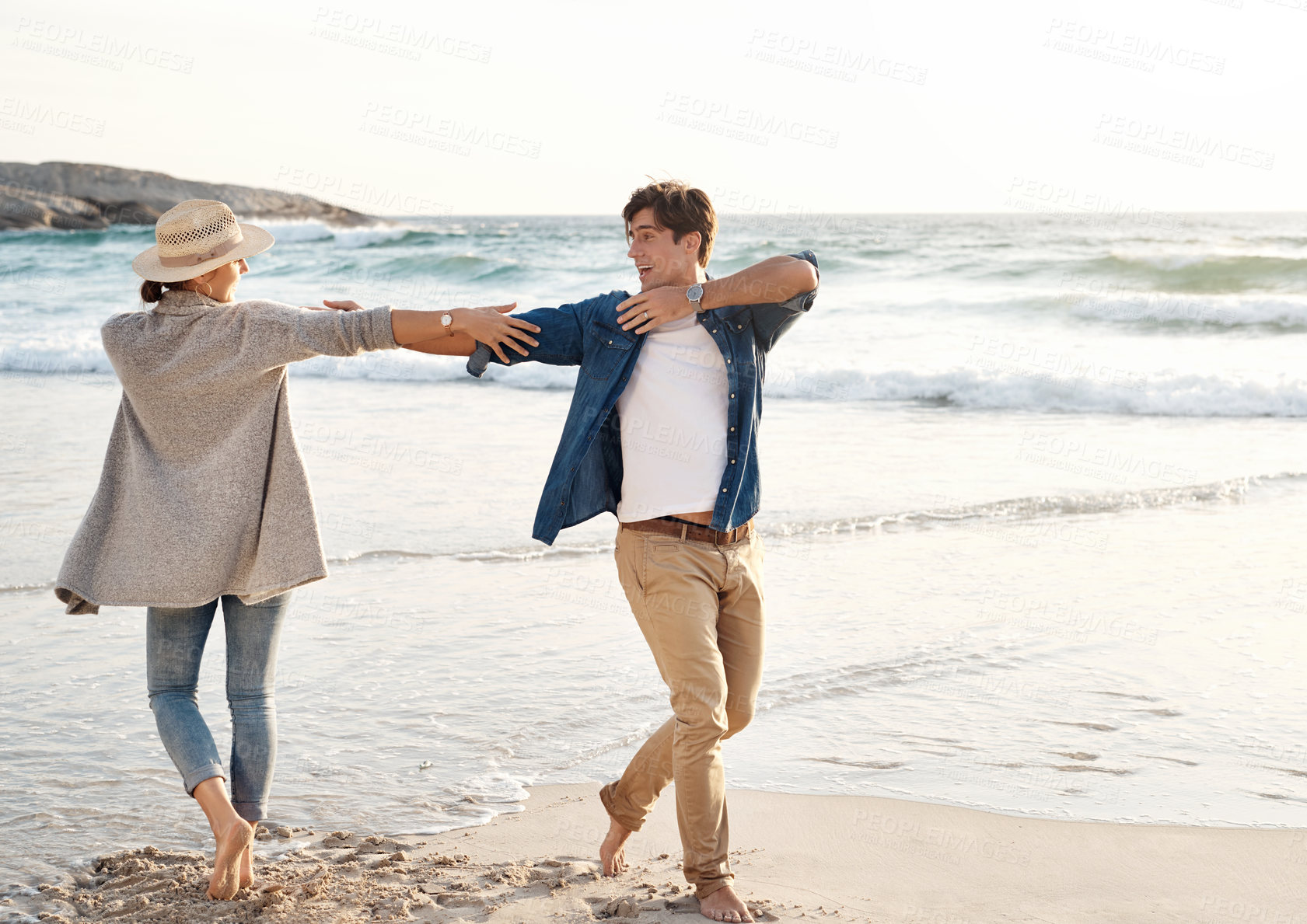 Buy stock photo Couple, dance and happy together on beach, seaside and holiday for relationship bonding and love or affection. Ocean, calm and fun with partners on vacation trip, relax and movement for joy on date