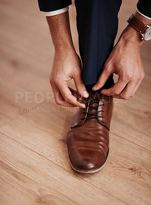 Buy stock photo Cropped shot of an unrecognizable man putting on his shoes