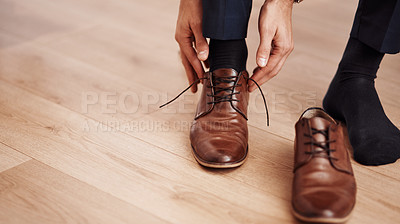 Buy stock photo Cropped shot of an unrecognizable man putting on his shoes