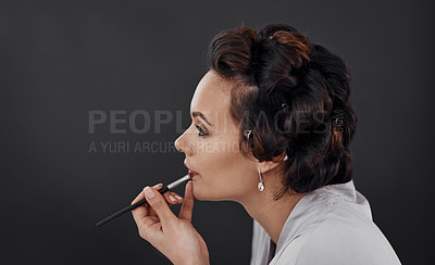 Buy stock photo Beauty, lip liner and woman with cosmetics application, natural skincare glow or facial makeup. Wellness, profile and studio person with skin treatment, dermatology or prepare on black background