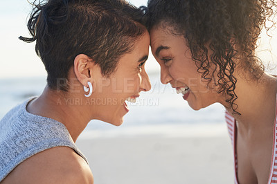 Buy stock photo Happy, couple and bonding by laughing at beach for summer game, travel vacation and playful reunion. Excited, lgbtq women and love connection for romance, relationship and support together by ocean