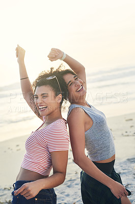 Buy stock photo Cropped shot of two female friends spending the day at the beach