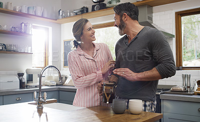 Buy stock photo Cropped shot of an affectionate couple standing in the kitchen at home
