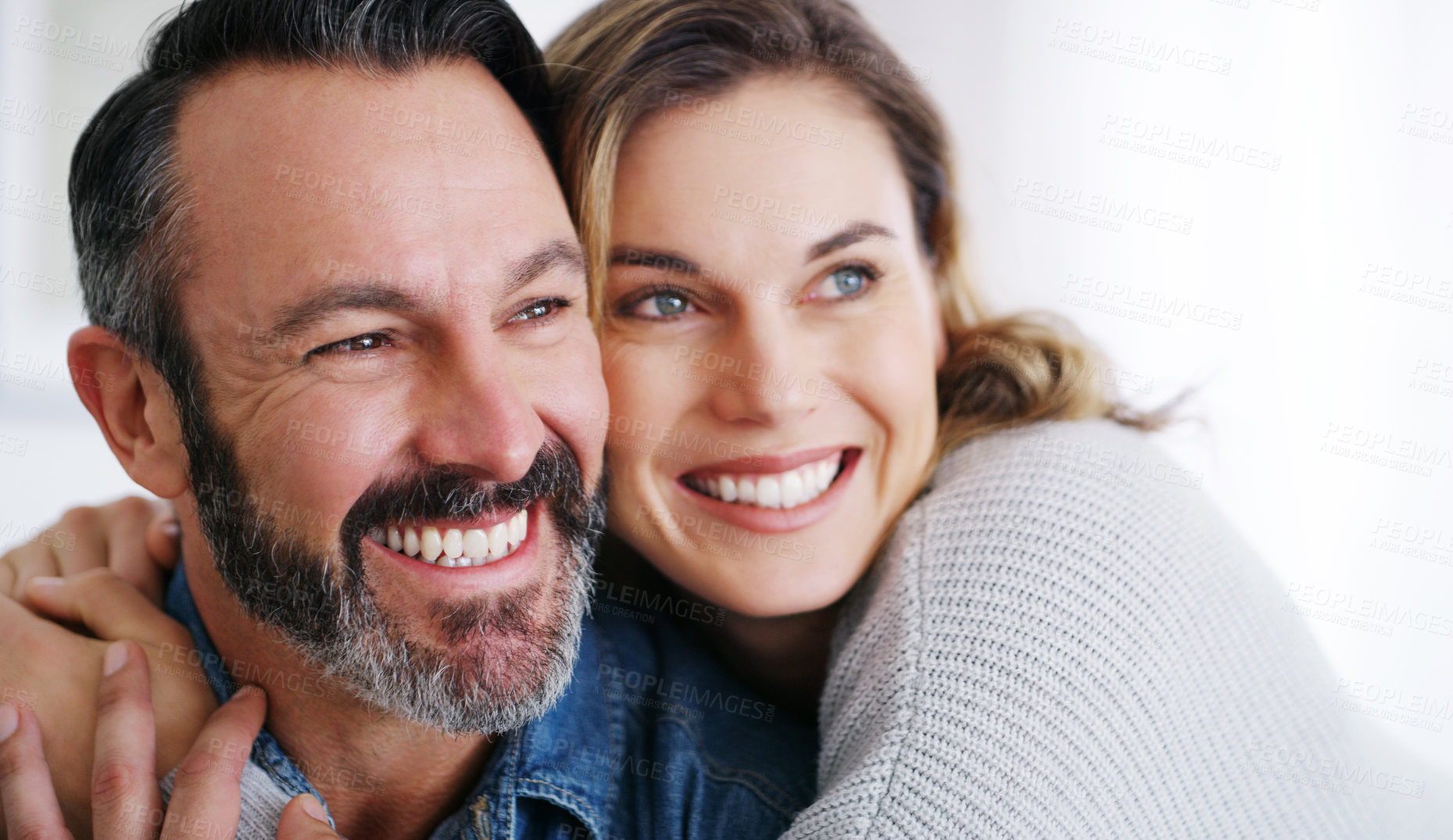 Buy stock photo Cropped shot of an affectionate couple relaxing together at home