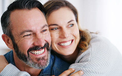 Buy stock photo Cropped shot of an affectionate couple relaxing together at home