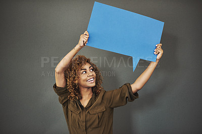 Buy stock photo Studio shot of a woman holding a speech bubble against a gray background