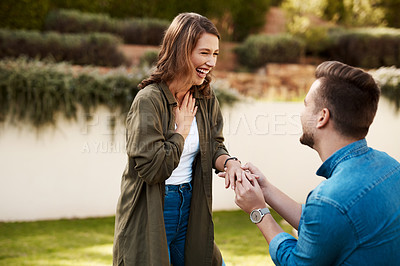 Buy stock photo Cropped shot of a young man proposing to his girlfriend