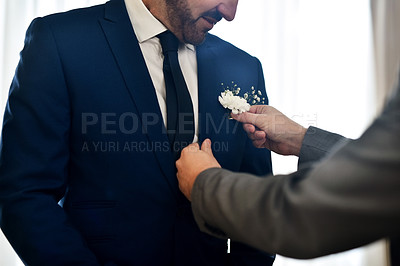 Buy stock photo Shot of an unrecognizable best man helping the bridegroom get dressed on his wedding day