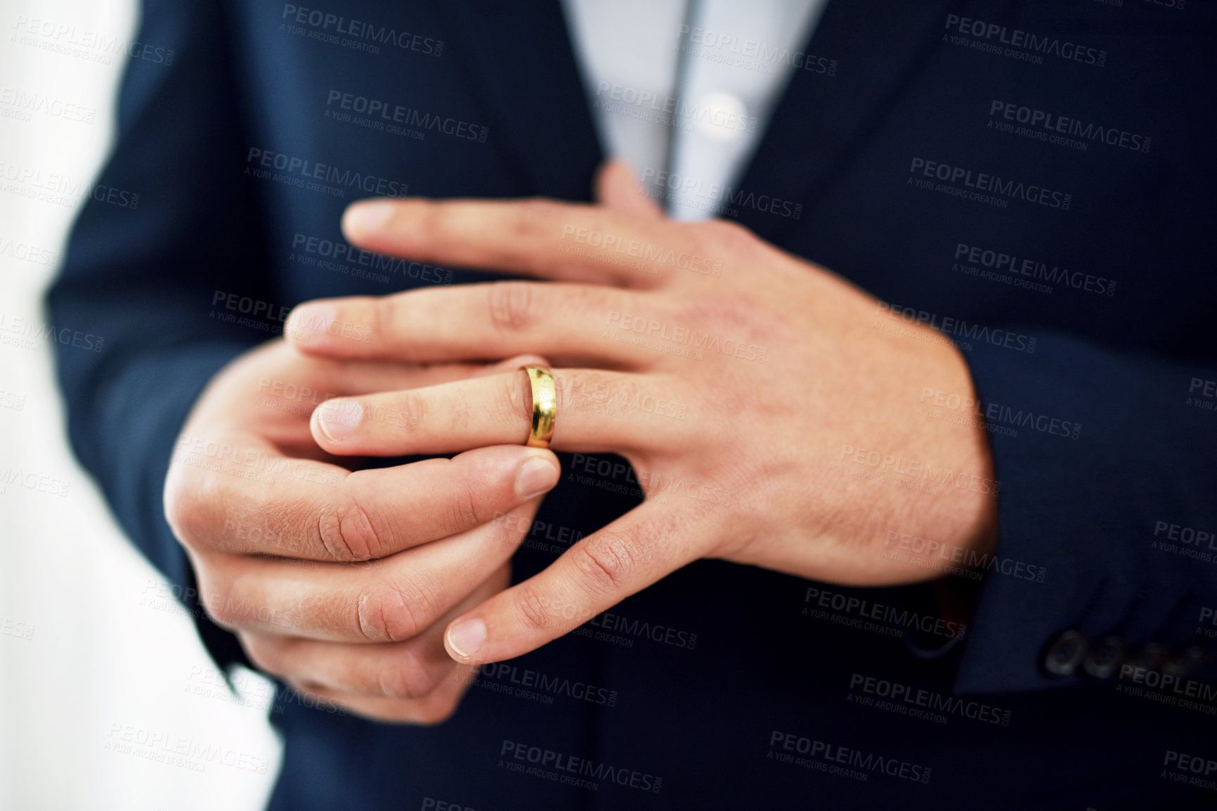 Buy stock photo Cropped shot of an unrecognizable bridegroom adjusting his ring on his wedding day
