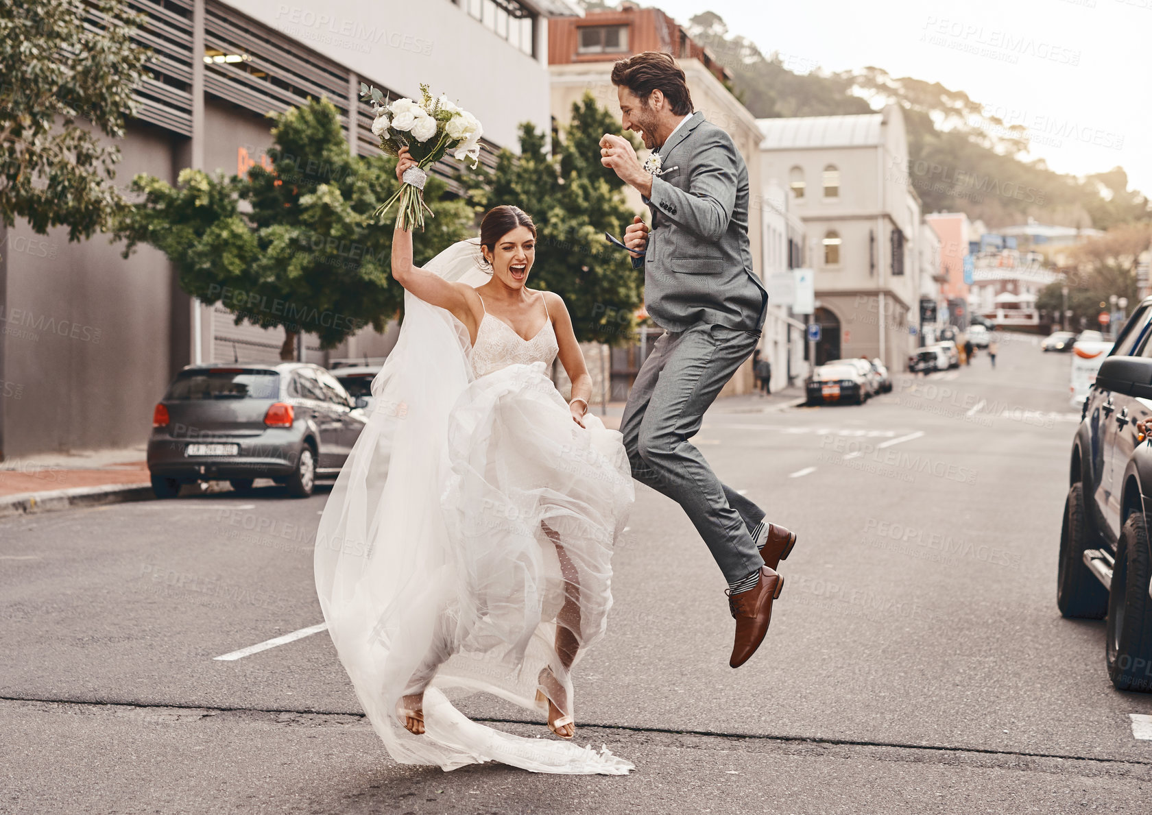 Buy stock photo Shot of a beautiful couple out in the city on their wedding day