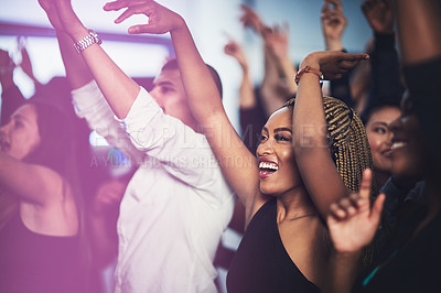 Buy stock photo Cropped shot of an attractive young woman cheering while standing in the crowd at a concert at night