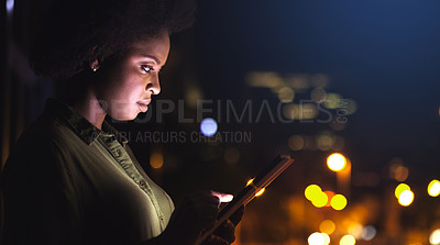 Buy stock photo Shot of a woman using a digital tablet while standing on the balcony of her office