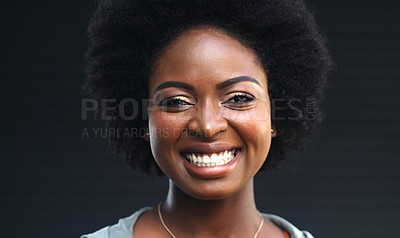 Buy stock photo Cropped shot of a happy young woman posing against a dark background