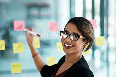 Buy stock photo Creative woman, portrait and writing on glass moodboard for ideas, brainstorming workflow or project priority. Business, biracial person with sticky notes and schedule, planning and creative solution