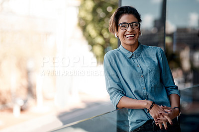 Buy stock photo Cropped portrait of an attractive young woman wearing earpods and standing on a balcony alone