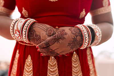 Buy stock photo Cropped shot of an unrecognizable bride standing with mehendi on her hands on the morning of her wedding