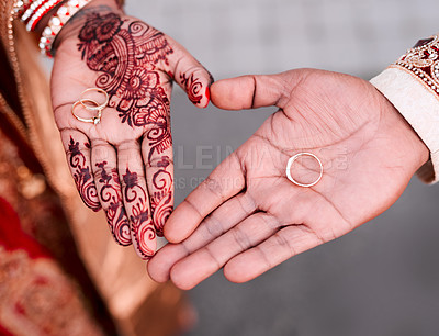 Buy stock photo Cropped shot of an unrecognizable couple making a heart shape with their hands while showing their rings on their palms on their wedding day