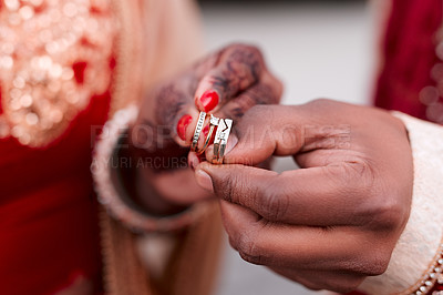 Buy stock photo Cropped shot of an unrecognizable couple holding their wedding rings together on their wedding day