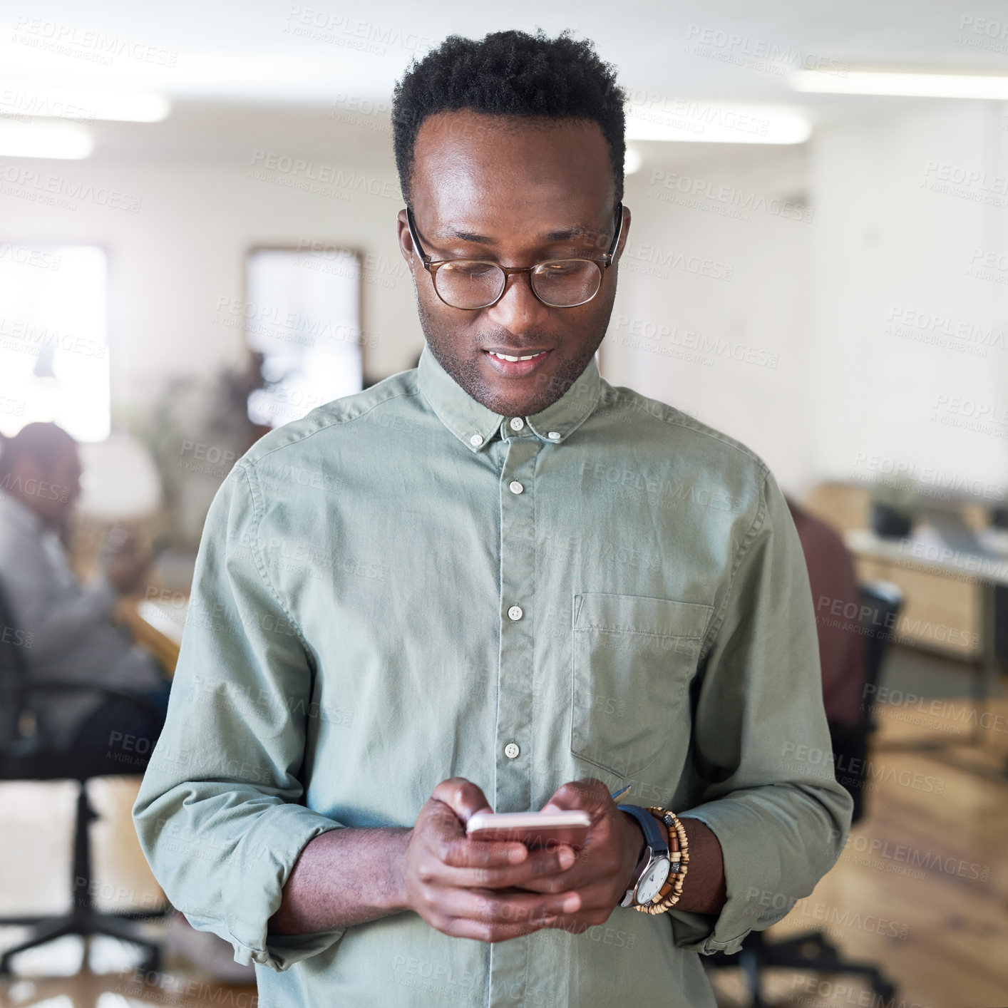 Buy stock photo Communication, phone and social media with professional black man in creative workplace for interaction. Email, data and online traffic with African employee typing on app or platform for visibility