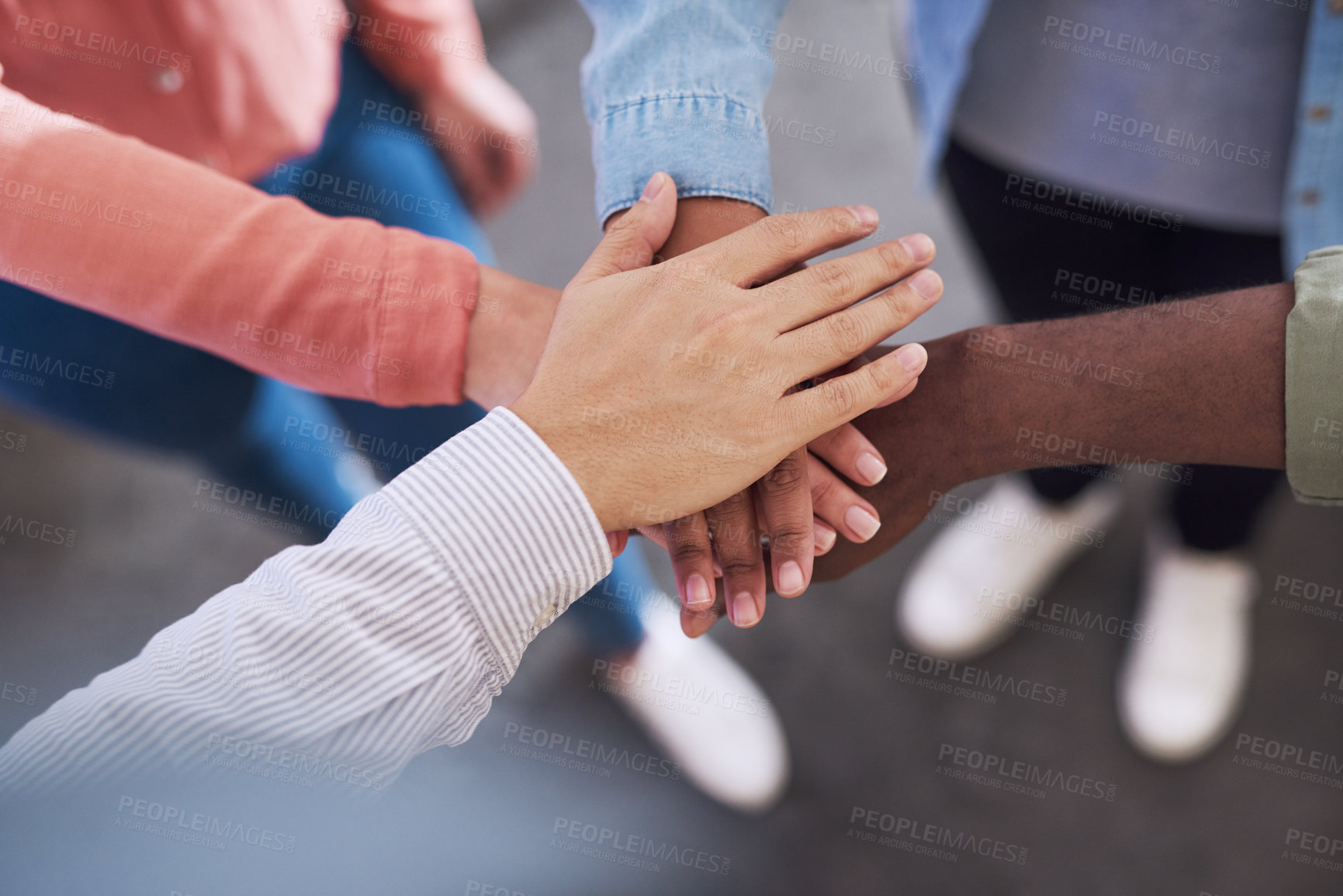 Buy stock photo Cropped shot of a group of businesspeople joining hands in solidarity in a modern office