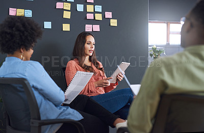 Buy stock photo Shot of a team of young businesspeople having a brainstorming session in a modern office