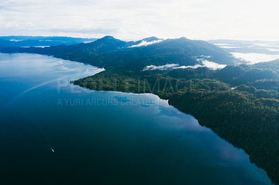 Buy stock photo High angle shot of beautiful green islands in the ocean