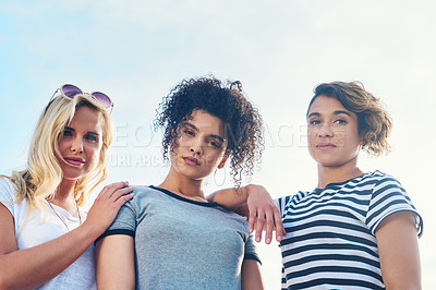 Buy stock photo Shot of three friends spending the day together on a sunny day