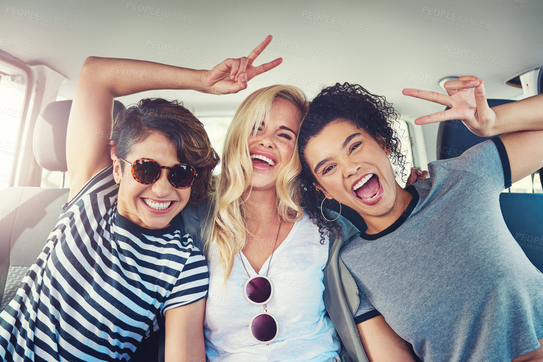 Buy stock photo Shot of girlfriends out on a road trip together