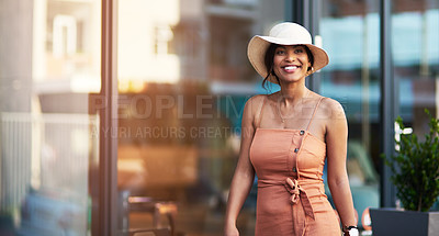 Buy stock photo Portrait of an attractive young woman feeling cheerful while out and about in the city