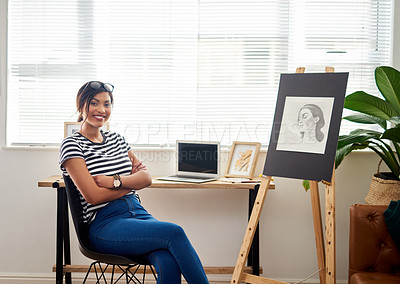 Buy stock photo Portrait of an attractive young artist smiling and feeling cheerful while sitting inside her studio at home