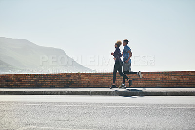 Buy stock photo Shot of a young couple out for a run together