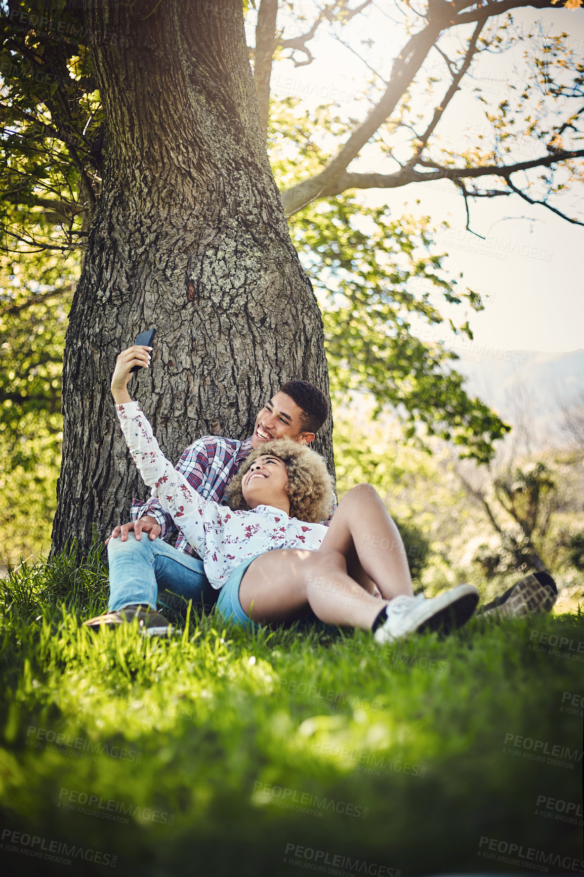 Buy stock photo Happy couple, relax and picnic in selfie for bonding, together and love in relationship or dating. Woman, man and park, garden or nature with outdoor on lawn, ground or grass on weekend or valentines