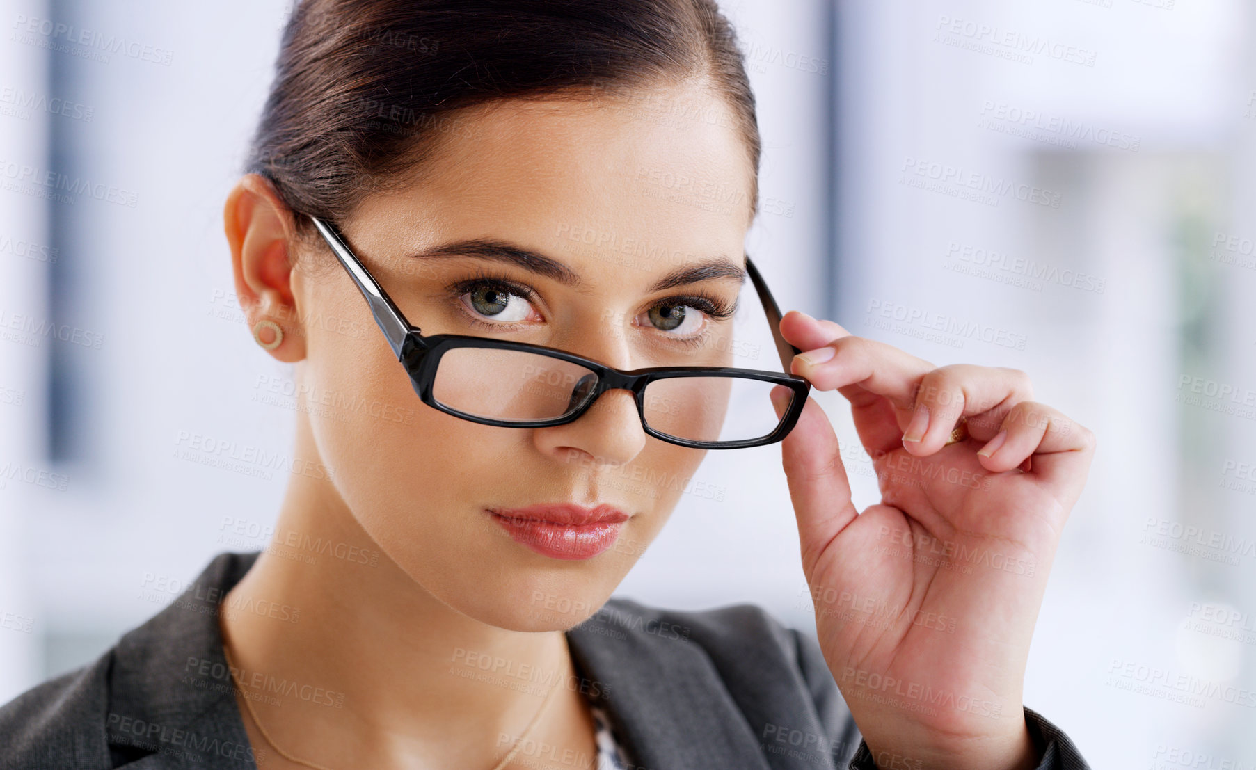 Buy stock photo Portrait of an attractive young businesswoman wearing spectacles while working in her office