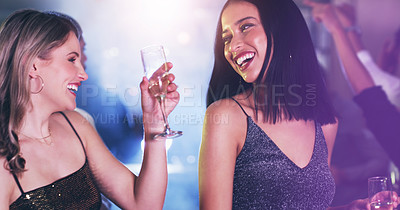 Buy stock photo Shot of two young women dancing in a nightclub