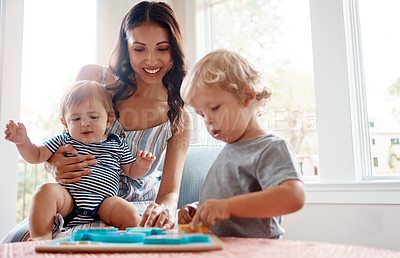 Buy stock photo Shot of a mother playing with her two little sons at home