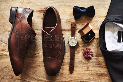 Buy stock photo Still life shot of formal shoes alongside a suit and other accessories on a wooden surface
