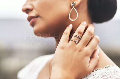 Buy stock photo Cropped shot of an an unrecognizable bride holding her neck and showing her ring on her wedding day