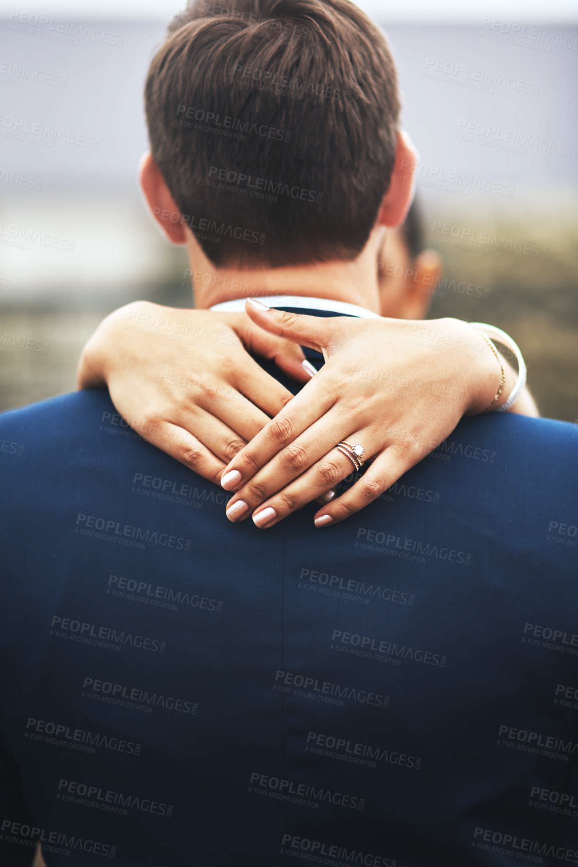 Buy stock photo Rearview shot of an unrecognizable newlywed young couple hugging and embracing on their wedding day