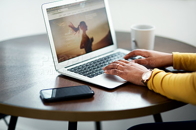 Buy stock photo Cropped shot of an unrecognizable woman sitting alone and using her laptop while at home